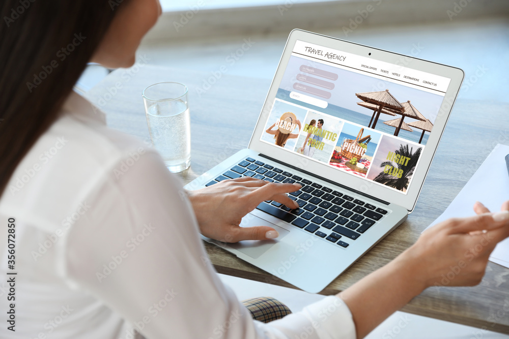 Woman using laptop to plan trip, closeup. Travel agency website - obrazy, fototapety, plakaty 
