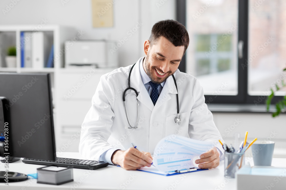 healthcare, medicine and people concept - smiling male doctor with clipboard at hospital healthcare, medicine and people concept - smiling male doctor with clipboard at hospital