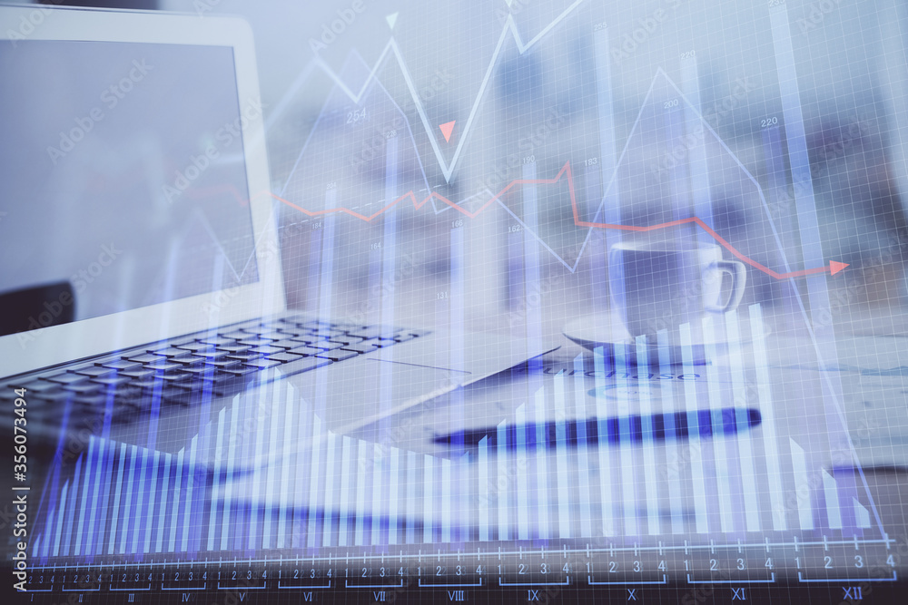 Forex graph hologram on table with computer background. Double exposure. Concept of financial markets. Forex graph hologram on table with computer background. Double exposure. Concept of financial markets.