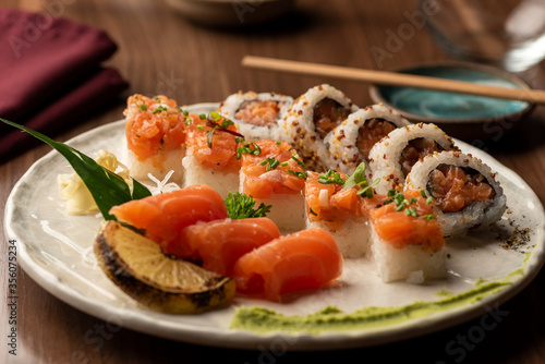 Japanese sushi sashimi salmon set on plate with napkin chopsticks on background