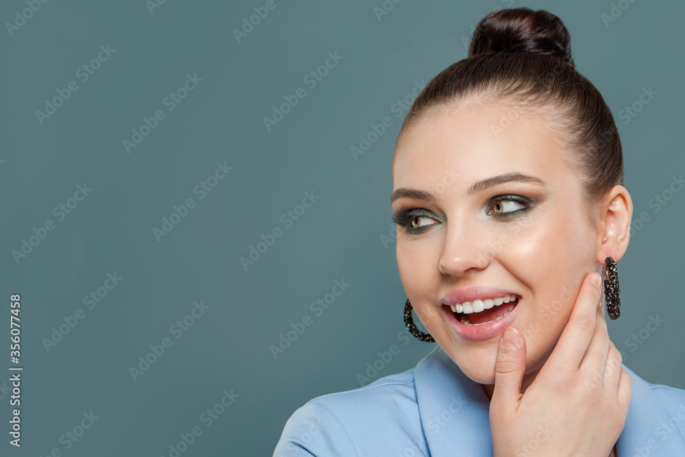 Happy beautiful woman on blue background. Perfect face closeup Happy beautiful woman on blue background. Perfect face closeup