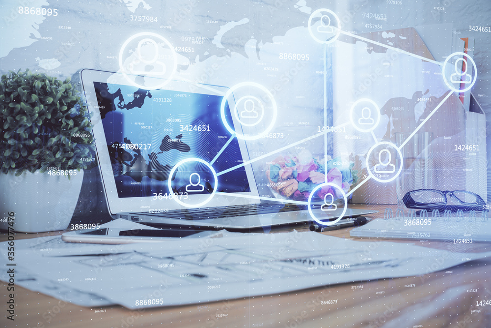 Computer on desktop with social network hologram. Multi exposure. Concept of international people connections. Computer on desktop with social network hologram. Multi exposure. Concept of international people connections.