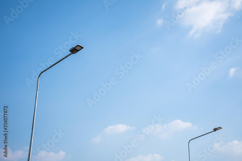 Street light LED on steel pole with blue sky and cloud.