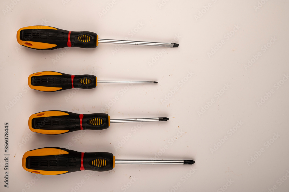 Different screwdrivers on a white background. Close up. Manual locksmith and installation tools for home work. Different screwdrivers on a white background. Close up. Manual locksmith and installation tools for home work.
