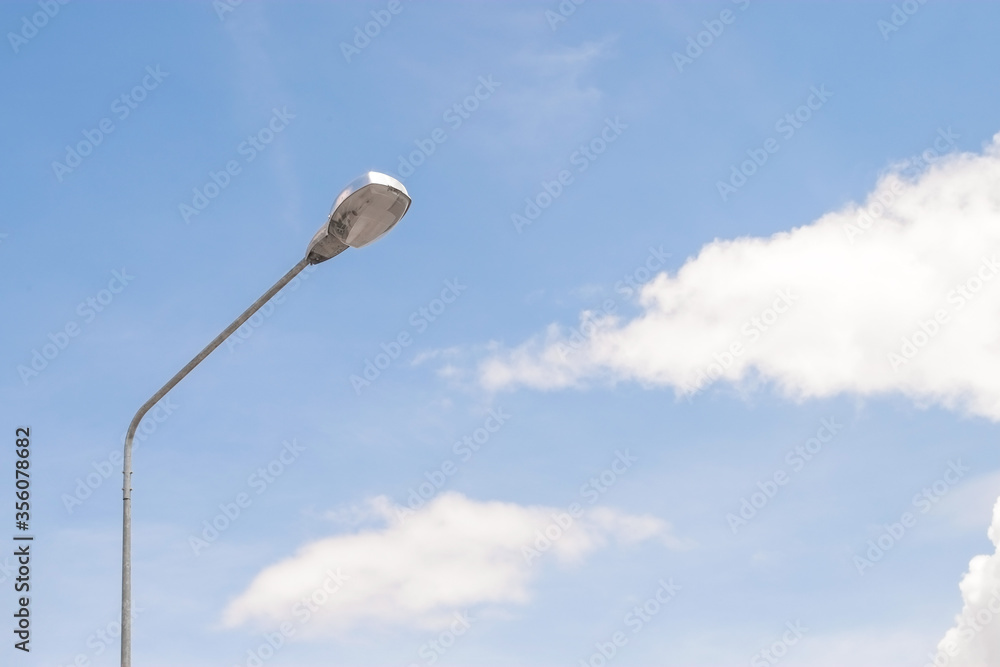 Street lighting bulb in daytime with blue sky close-up. Street lighting bulb in daytime with blue sky close-up.