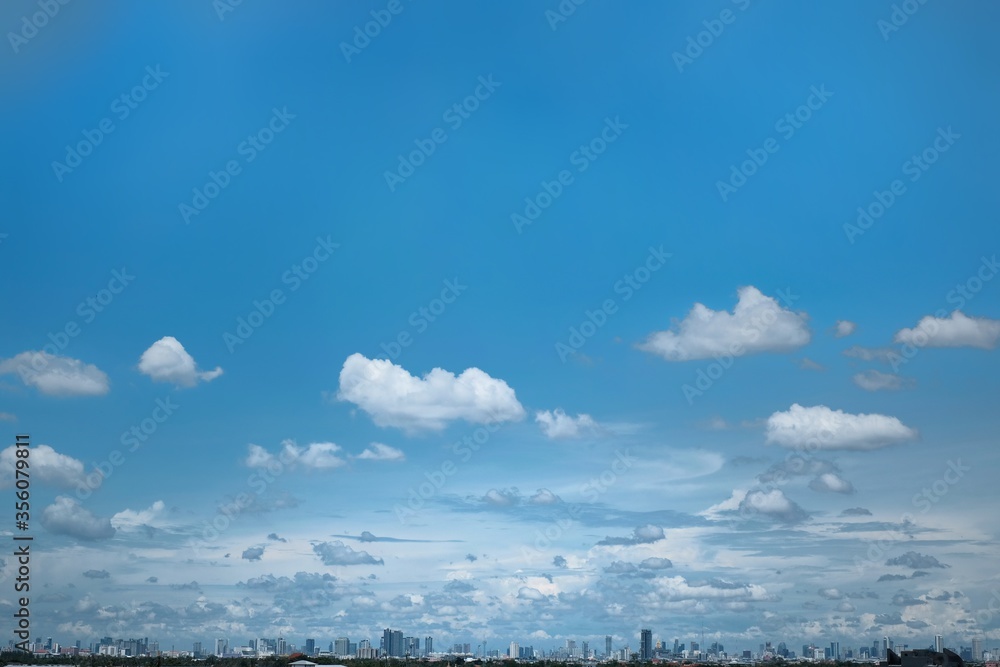 Blue sky background with white transparent clouds with cityscape , Can including free copy space ,  City and many buildings for financial or ecology concept background website or art work design.