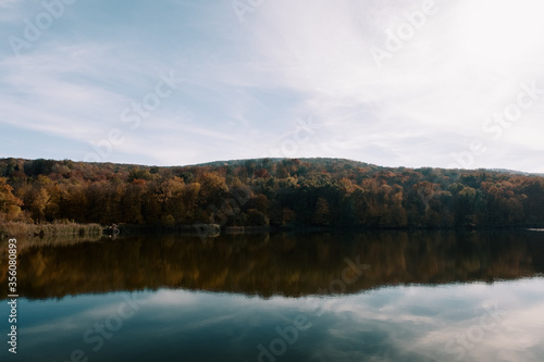 Landscape background, sky, reflection in the morning lake. Tourism, journey, discover the world