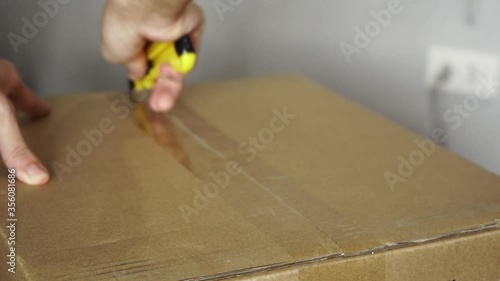 Open a sealed cardboard box with utility knife