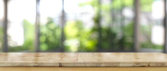 Empty wooden counter bar, wooden table with blurred backyard background