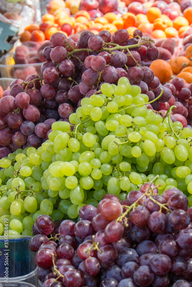 green and purple grapes in a market green and purple grapes in a market