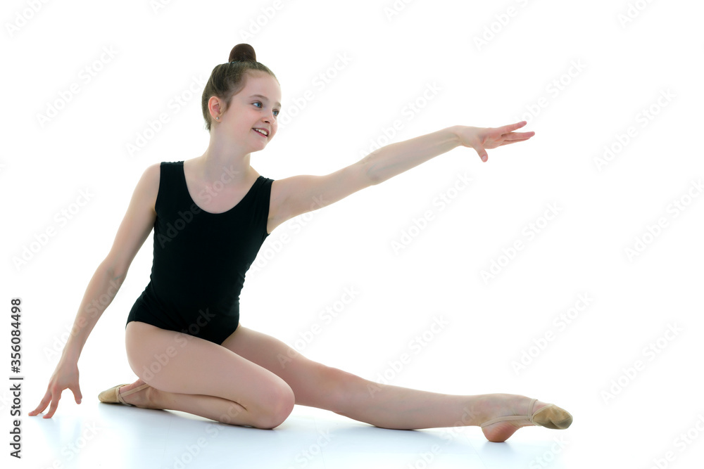 The gymnast perform an acrobatic element on the floor. The gymnast perform an acrobatic element on the floor.
