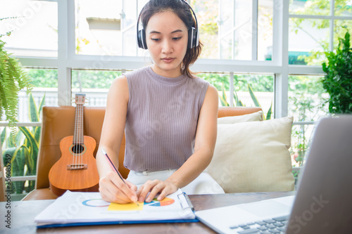 Asian businesswomen is using notebook computers and wear headphones for online meetings and working from home. Free Download Asian businesswomen is using notebook computers and wear headphones for online meetings and working from home. - GFXLoad