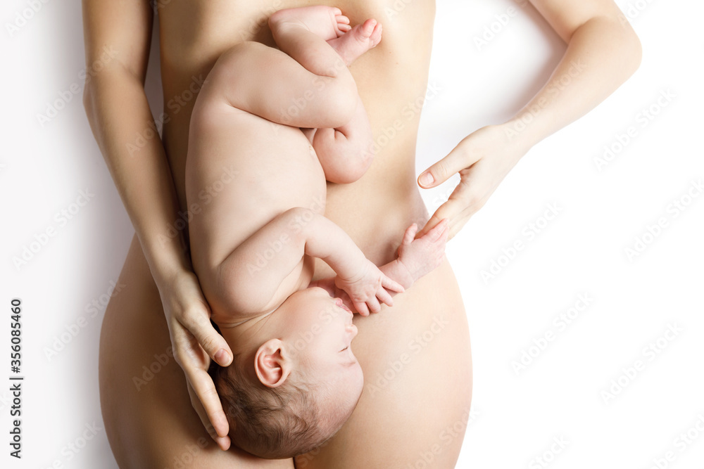 Cute newborn baby lying on the mother belly