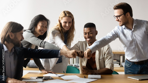 Konstfotografi Horizontal image middle-aged and young five multiracial staff members gather in