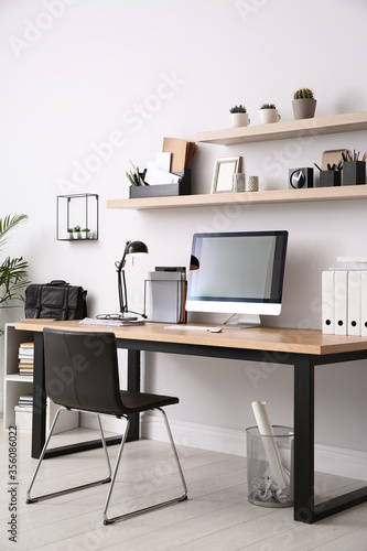 Modern computer on table in office interior. Stylish workplace