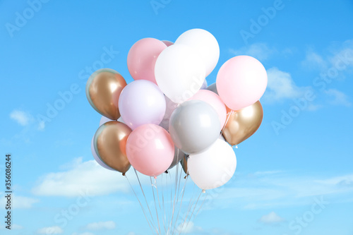 Bunch of colorful balloons outdoors on sunny day