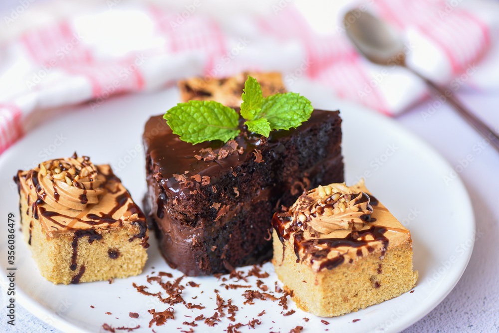 Coffee cake topping chocolate delicious sweet dessert served on the table - cake chocolate slice on white plate with mint leaf for breakfast Coffee cake topping chocolate delicious sweet dessert served on the table - cake chocolate slice on white plate with mint leaf for breakfast