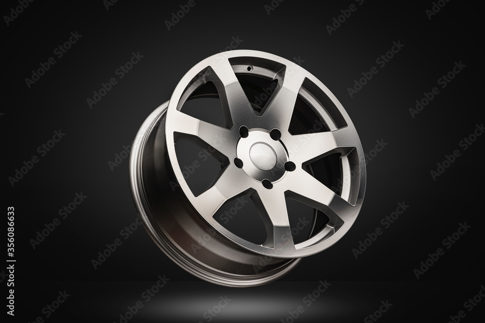 Fototapeta premium New polished silver alloy wheel on dark gradient background. modern design