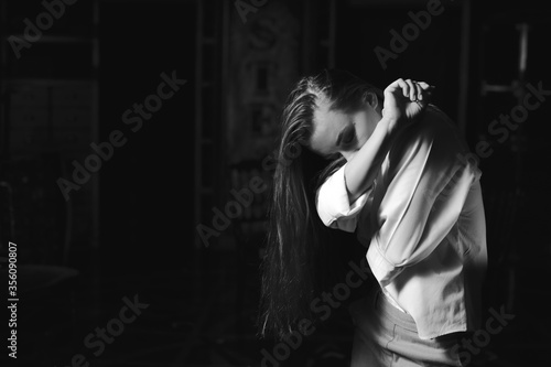 Black and white portrait of beautiful dancing caucasian girl with dramatical emotion on the stage.Retro fashion. Black and white image. photo