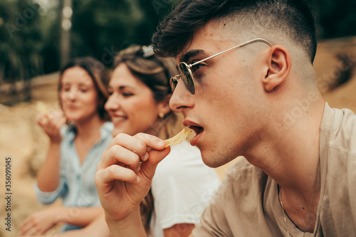 Young people eating potato chips