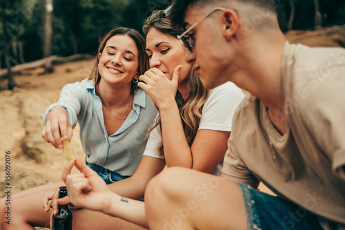 Young people eating potato chips.