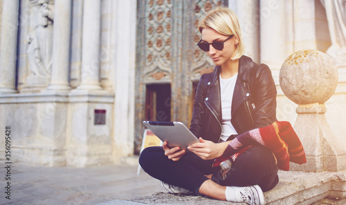 Photography Female tourist is searching in internet via digital tablet information about hi