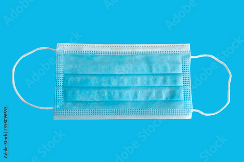 Medical mask on a blue background .