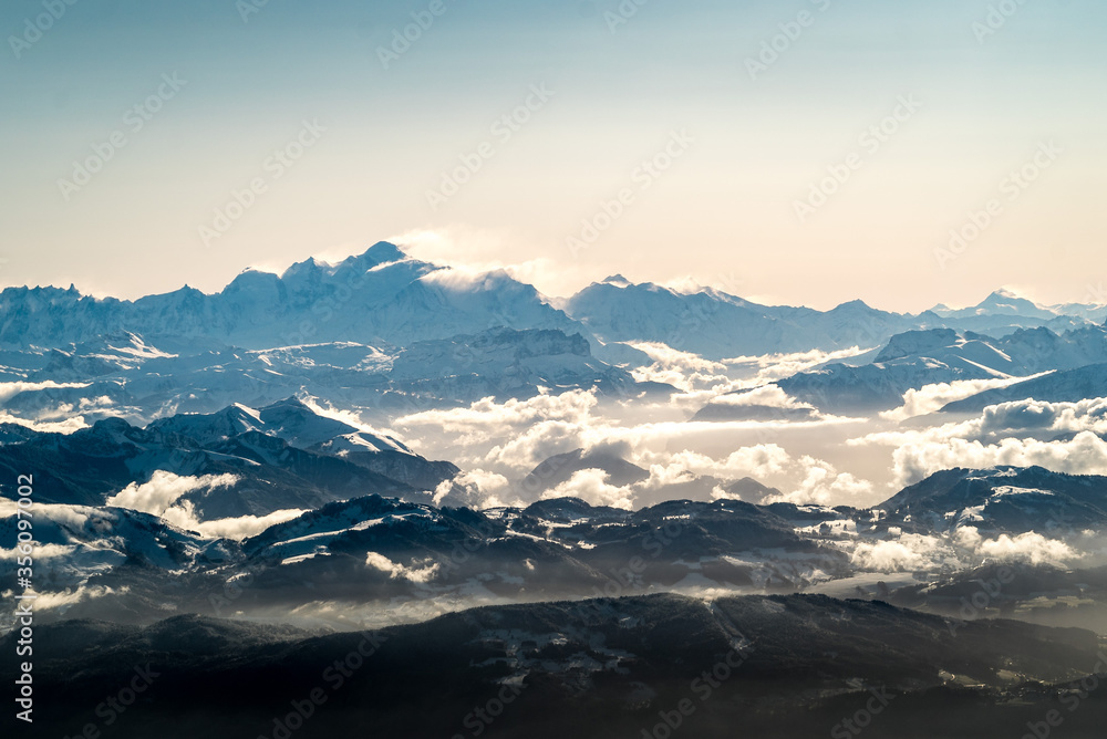 Sunrise over Mont Blanc mountain range from a plane above french alps