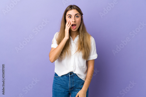Young woman over isolated purple background with surprise and shocked facial expression