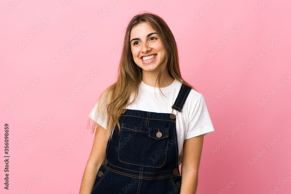 Young woman over isolated pink background thinking an idea while looking up Young woman over isolated pink background thinking an idea while looking up