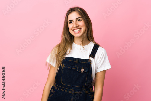 Young woman over isolated pink background thinking an idea while looking up