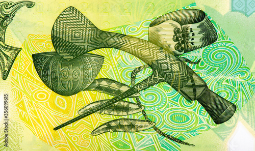 Mount Hagen axe, Kula arm band from the Milne Bay Province, engraved dog's teeth from the Bougainville area, Portrait from Papua New Guinea 2 Kina 2007 Polymer Banknotes. Collection. photo