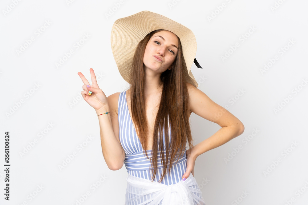 Young caucasian woman isolated on white background in swimsuit in summer holidays and doing victory gesture Young caucasian woman isolated on white background in swimsuit in summer holidays and doing victory gesture