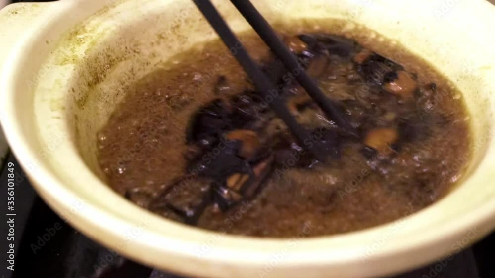 Close up of boiling Bamboo Weevil beetle snack in hot clay pot Close up of boiling Bamboo Weevil beetle snack in hot clay pot