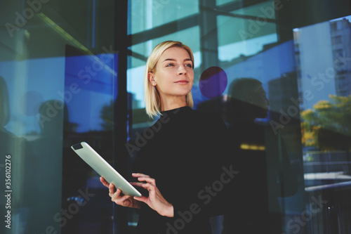 Tableau sur toile Portrait of beautiful young female holding mobile phone in hands
