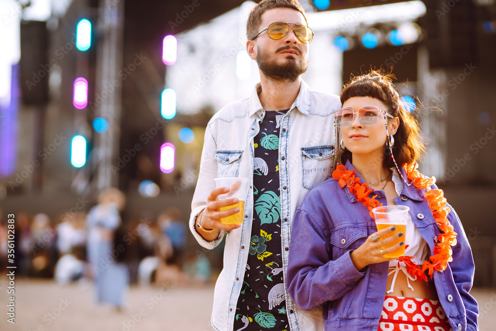 Couple with beer at music festival. Beach party, summer holiday, vacation concept. Couple with beer at music festival. Beach party, summer holiday, vacation concept.