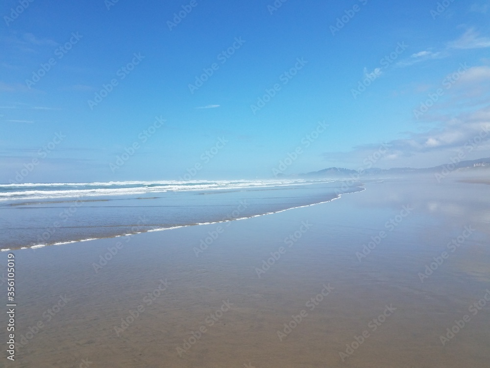 ocean water and sand at the beach in Newport, Oregon