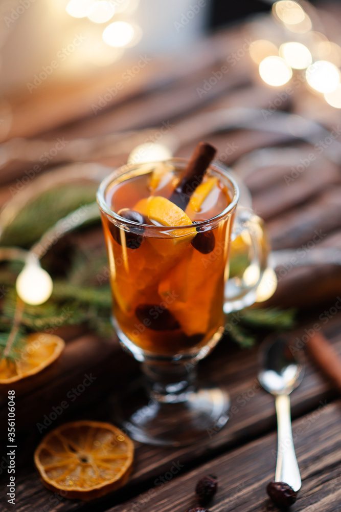 Cup of tea with ginger and cinnamon on wooden background
