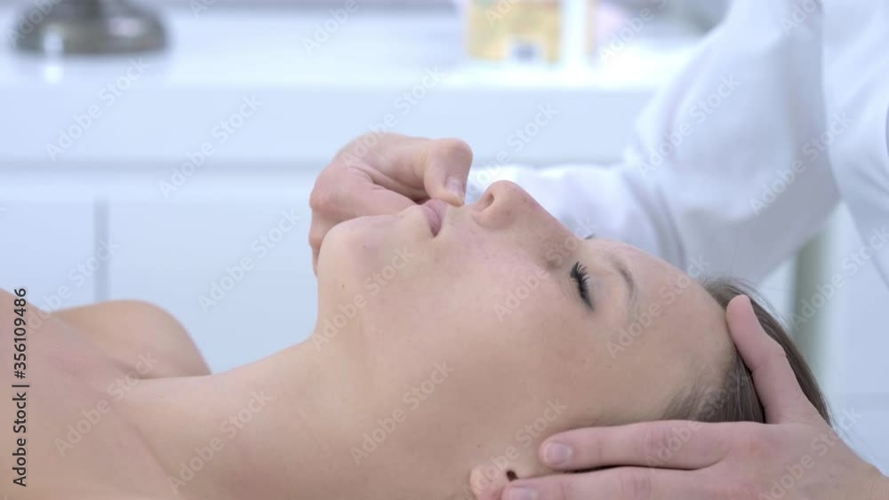 Close-up 4K video of woman enjoying japanese face massage in professional salon Close-up 4K video of woman enjoying japanese face massage in professional salon