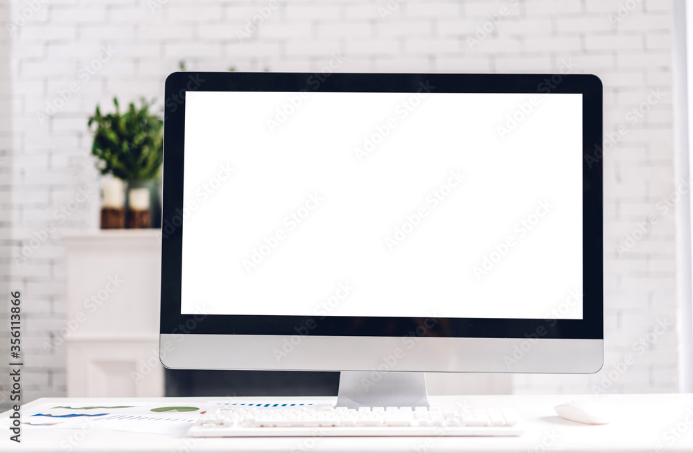 Creative desktop computer with white mockup blank screens on table in modern minimal white work loft Creative desktop computer with white mockup blank screens on table in modern minimal white work loft