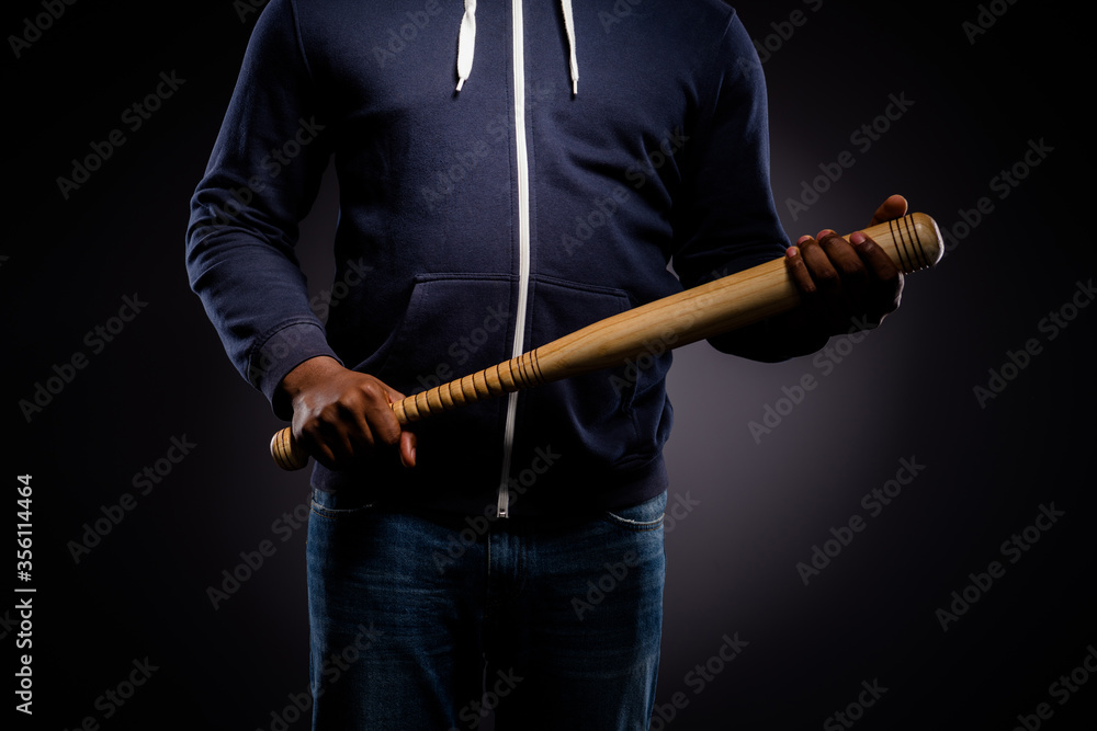 Cropped photo of afro american guy hold baseball beat ready fight for african people rights isolated over black color background Cropped photo of afro american guy hold baseball beat ready fight for african people rights isolated over black color background