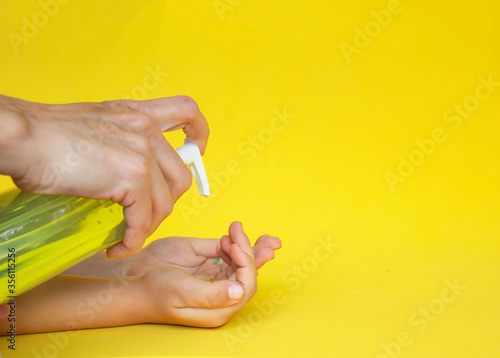 baby hand wash on a yellow background, the concept of clean hands