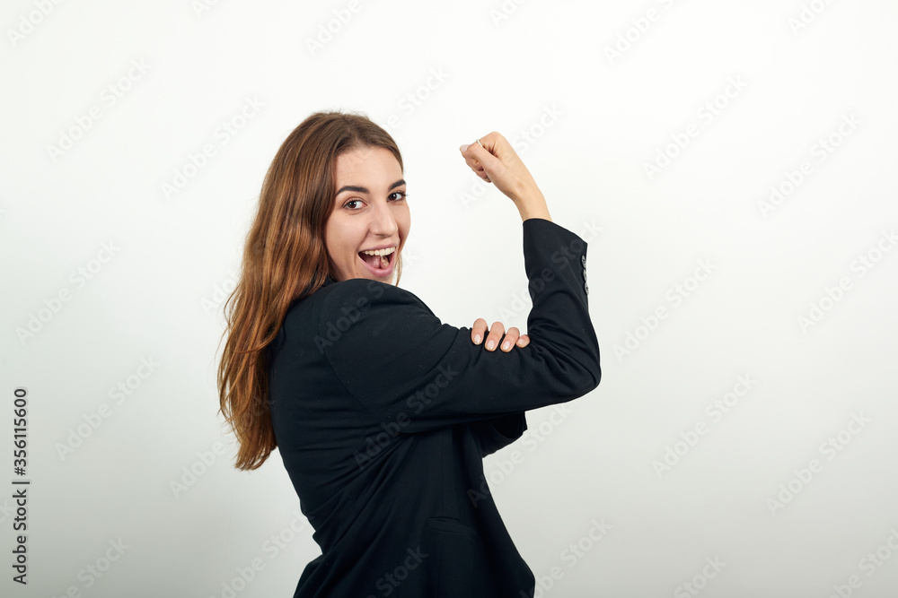 Feels proud have strength, shows great power, raises arms to show muscles confident in victory, looks strong and independent, flexing arm, facial expressions, feelings, attitude, life perception