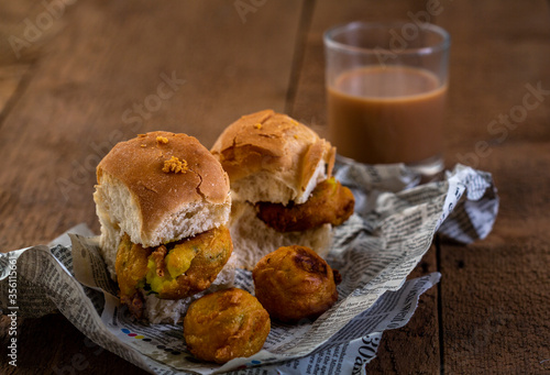 vada pav with a glass of tea, very famous street food of india, specially in the state of Maharashtra, selective focus