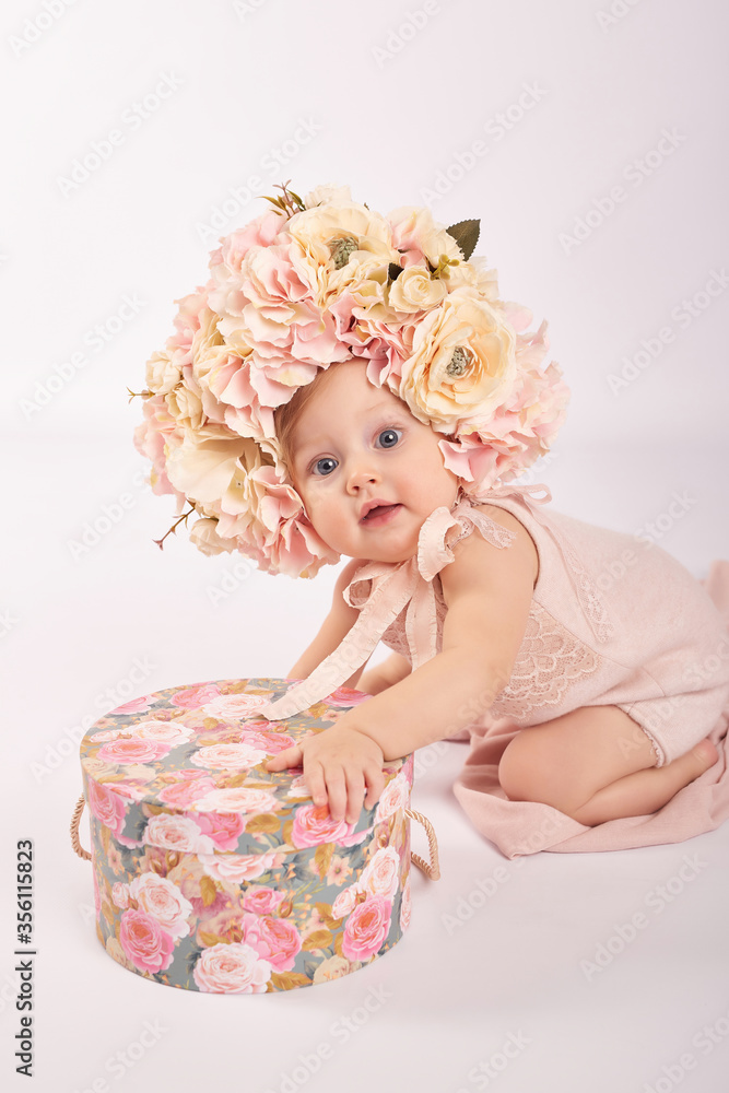 Sweet funny baby in hat with flowers. Easter greeting card, copyspace for your text. Poster for Easter holiday. Congratulations on Mother's Day. Cute baby girl. Children Protection Day Sweet funny baby in hat with flowers. Easter greeting card, copyspace for your text. Poster for Easter holiday. Congratulations on Mother's Day. Cute baby girl. Children Protection Day