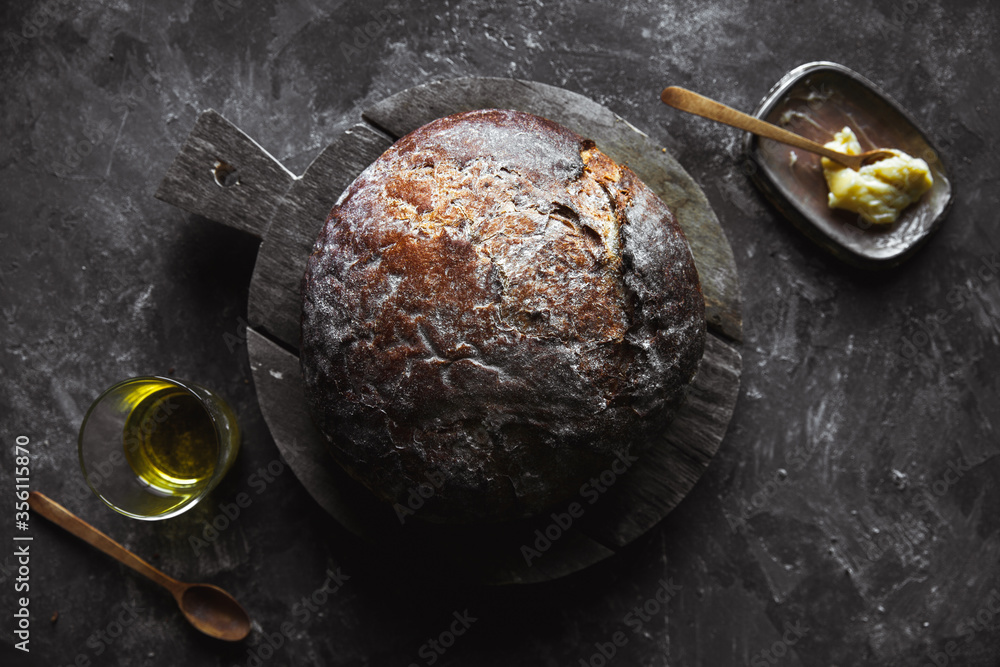 Fototapeta premium Fresh Baked bread on dark background