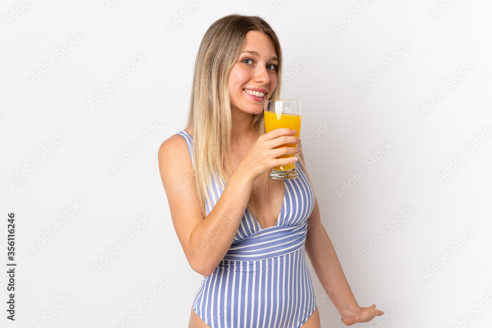 Young blonde woman isolated on white background in swimsuit and holding a cocktail Young blonde woman isolated on white background in swimsuit and holding a cocktail