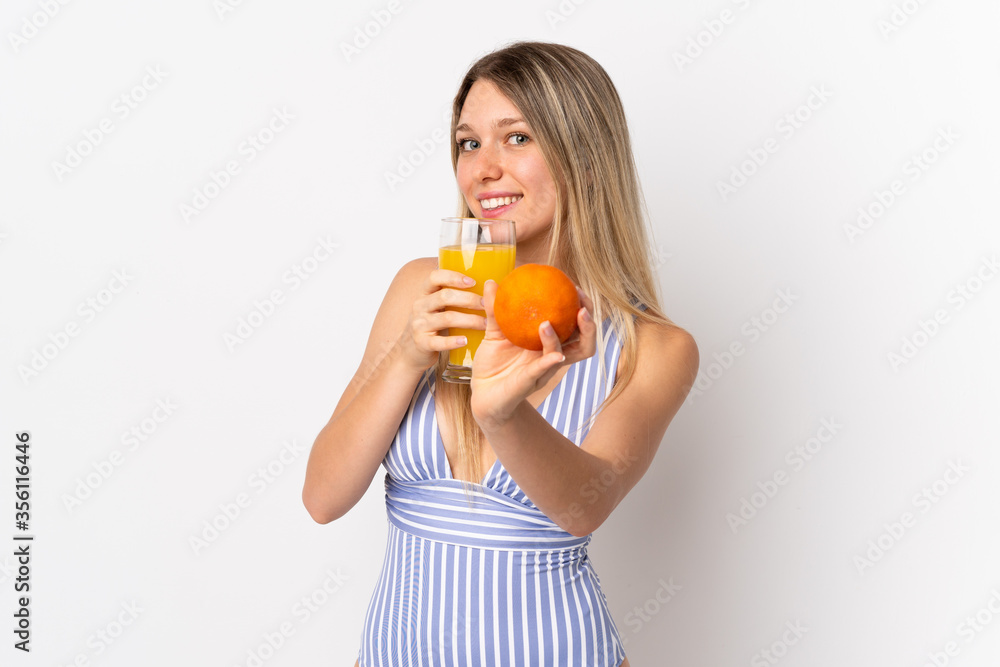 Young blonde woman isolated on white background in swimsuit and holding a cocktail Young blonde woman isolated on white background in swimsuit and holding a cocktail