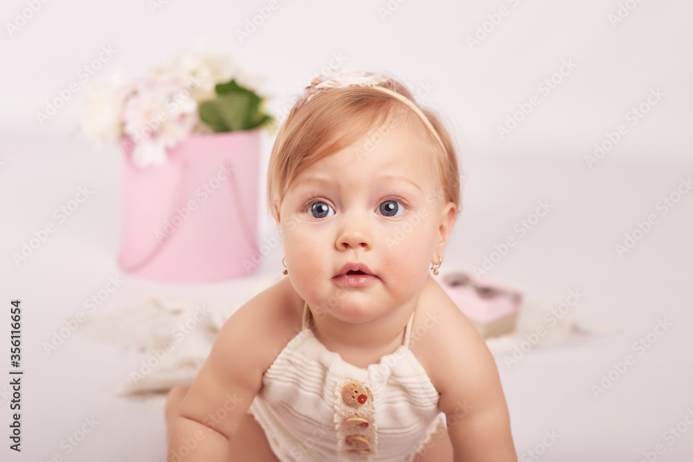 Sweet funny baby in hat with flowers. Easter greeting card, copyspace for your text. Poster for Easter holiday. Congratulations on Mother's Day. Cute baby girl. Children Protection Day. Sweet funny baby in hat with flowers. Easter greeting card, copyspace for your text. Poster for Easter holiday. Congratulations on Mother's Day. Cute baby girl. Children Protection Day.