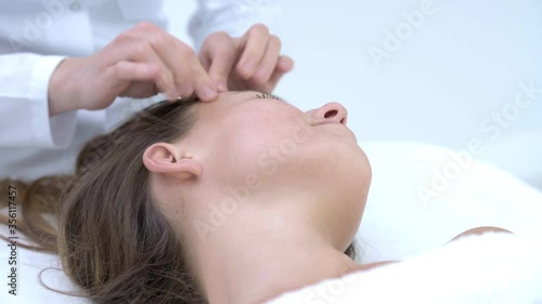 Close-up 4K video of woman enjoying japanese face massage in professional salon